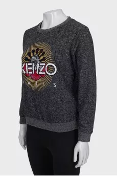 Gray sweatshirt decorated with embroidery