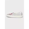 White slip-ons decorated with rhinestones