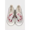 White slip-ons decorated with rhinestones
