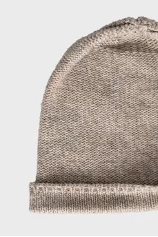 Knitted hat decorated with leather cord