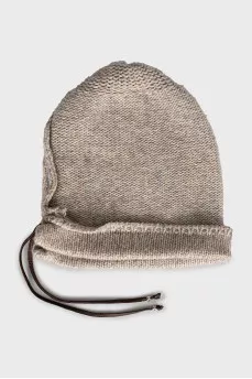 Knitted hat decorated with leather cord