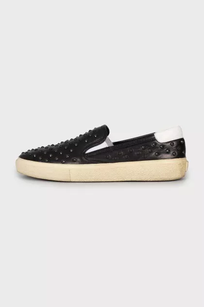 Leather slip-ons decorated with studs