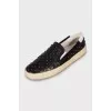 Leather slip-ons decorated with studs