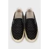 Leather slip-ons decorated with studs