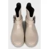 Rubber boots decorated with a strap