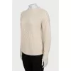 Beige sweater with a relief pattern