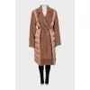 Coat decorated with fringe and tag