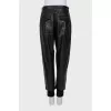 Leather trousers with textile inserts
