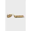 Gold earrings in the shape of a spike