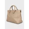 Leather bag with branded logo on the clasp