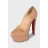 Beige high heel shoes