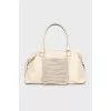 Leather bag with woven pocket