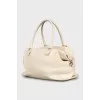 Leather bag with woven pocket