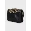 Leather clutch with metal decor