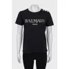 Black T-shirt with silver buttons