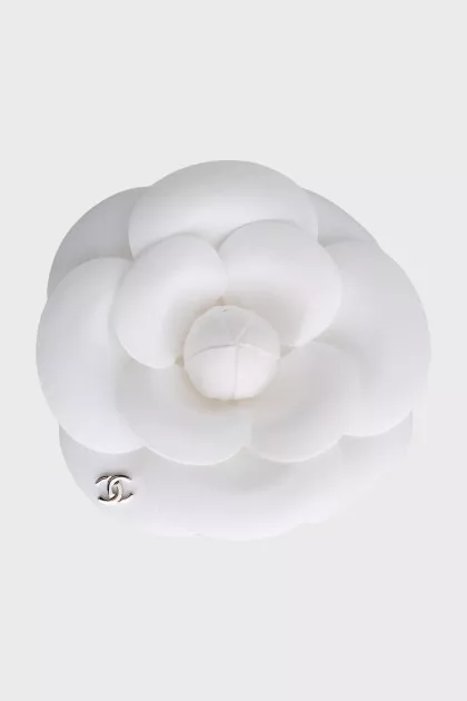 Brooch in the form of a camellia with a brand logo