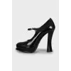 Black leather shoes with a figured heel