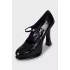 Black leather shoes with a figured heel