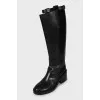 Leather boots decorated with straps
