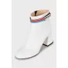 White ankle boots with trapezoid heels