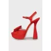 Red sandals decorated with bows