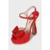 Red sandals decorated with bows