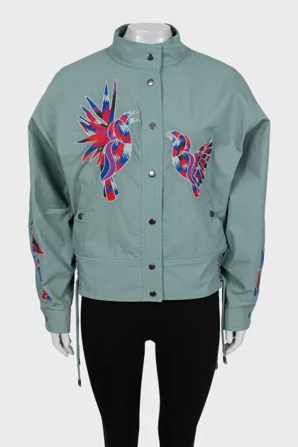 The loose-fitting jacket is decorated with embroidery