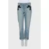 The jeans are decorated with mesh and sequins