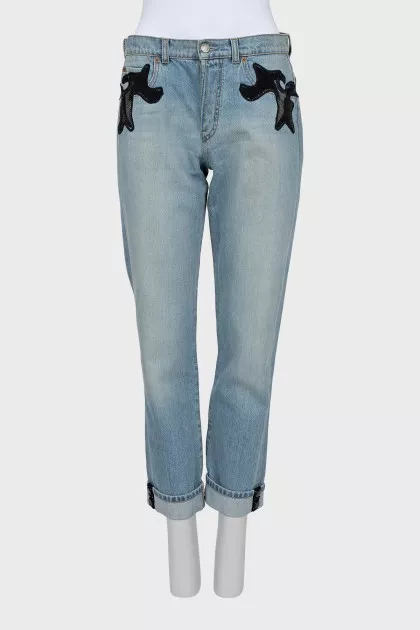 The jeans are decorated with mesh and sequins