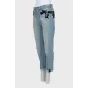 The jeans are decorated with mesh and sequins