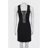 The fitted dress is decorated with lacing