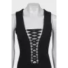 The fitted dress is decorated with lacing