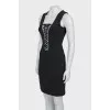 The fitted dress is decorated with lacing