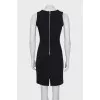 The fitted dress is decorated with lacing