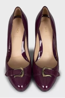 Patent leather shoes decorated with straps