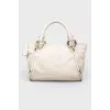 Dairy leather bag with golden fittings