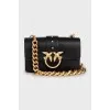 Leather bag with a massive strap