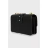 Leather bag with a massive strap