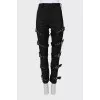Tapered trousers decorated with straps