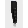 Tapered trousers decorated with straps