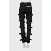 Tapered trousers decorated with straps