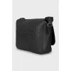 Leather bag with textile strap with tag