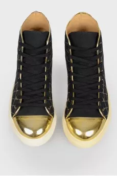 Sneakers with a golden toe with a tag