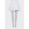 Skirt with rhinestones on the hem with a tag