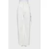 White jeans decorated with a rhinestone cord