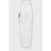 White jeans decorated with a rhinestone cord
