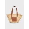 Woven bag with leather handles and logo