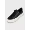 Black leather sneakers with embossing
