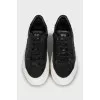 Black leather sneakers with embossing