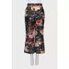Black floral print trousers with tag